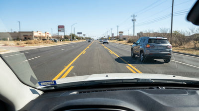 A car hire driving down a multi-lane road in Texas with a clearly marked center turning lane