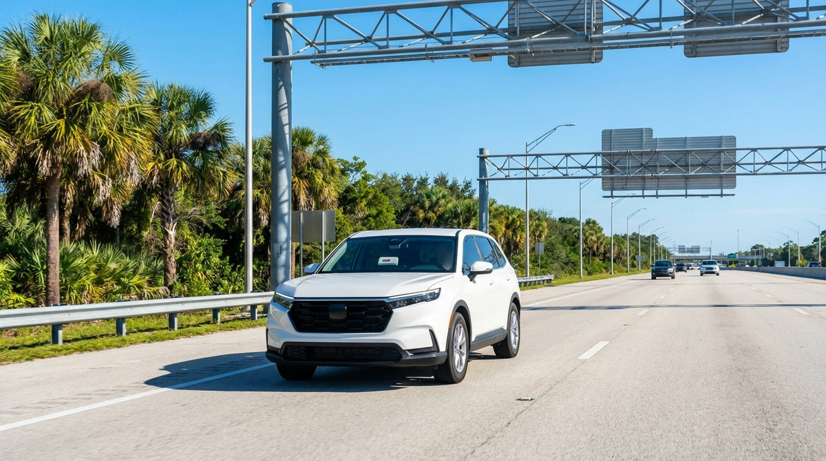 A modern car hire drives across a long, sunny bridge spanning the blue ocean in the Florida Keys