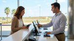 A traveler holding an open passport and keys at a car rental desk in Texas
