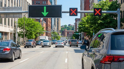 A car hire in rush hour traffic on a Pittsburgh bridge under green arrow lane control signals in Pennsylvania