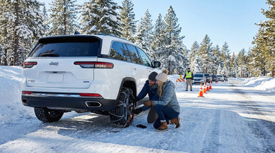 A car hire driving on a scenic, snow-covered mountain road on a winter trip from Los Angeles