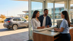 A smiling couple stands by their car hire on a scenic Texas highway at sunset
