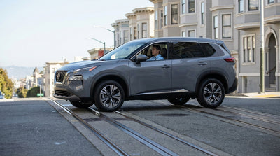 A modern car rental navigating the famous hilly streets and cable car tracks of San Francisco