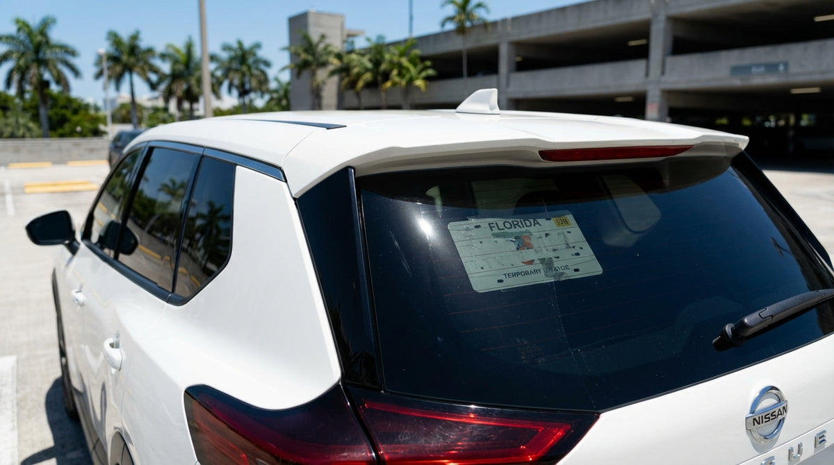 A stylish hire car parked under palm trees on a sunny, vibrant street in Miami's South Beach