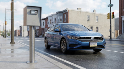 A car hire drives through an intersection with a speed camera on a city street in Philadelphia, Pennsylvania