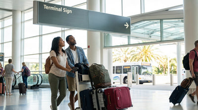 A family with suitcases walking through Orlando Airport on their way to the car rental desks