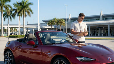 A modern white convertible car rental parked on a scenic coastal road with palm trees in sunny Florida