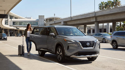 A car hire drops off a passenger at the busy departures curb of the LAX airport terminal in Los Angeles