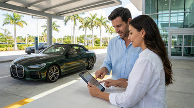 A person at a counter reviewing their car hire agreement paperwork before driving in Florida
