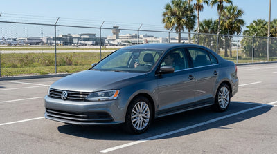 A driver waits in their car hire vehicle at the sunny LAX Cell Phone Waiting Lot in Los Angeles