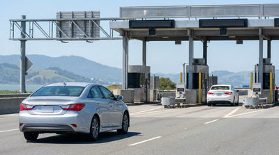 A white car rental driving across the Golden Gate Bridge in San Francisco with the bay below