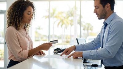 A red convertible car rental driving along a sunny coastal highway lined with palm trees in Florida
