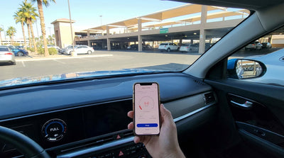 A modern car rental driving towards the Las Vegas Strip hotels on a highway at sunset