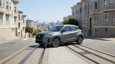 A car hire vehicle driving down a steep, iconic street lined with classic homes in San Francisco