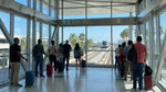 The MIA Mover train arriving at the elevated car rental station at Miami Airport under a clear blue sky