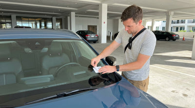 A modern car hire parked inside a well-lit Las Vegas hotel parking garage next to a concrete pillar