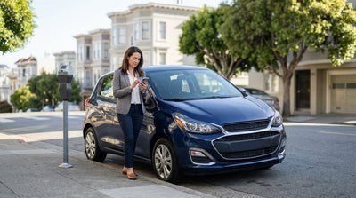 A car rental parked on a steep San Francisco street with classic Victorian houses in the background