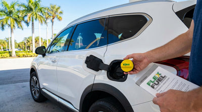 A driver considers the E85 fuel option at a gas station pump for their Orlando car hire