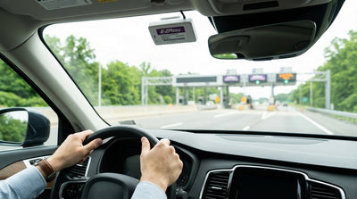 View from inside a car hire approaching a highway toll plaza with E-ZPass lanes in Pennsylvania