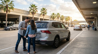 A line of people wait at the car rental counter inside the arrivals hall of Houston Airport, Texas