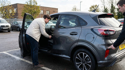 Close-up of a car rental infotainment screen showing the reverse camera view in a Pennsylvania parking lot
