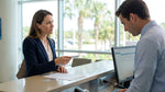 Customer handing a credit card to an agent at an Orlando car hire desk