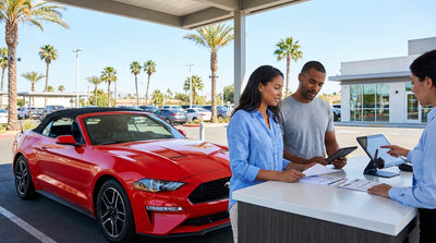 A modern car hire drives on a scenic highway along the sunny coast of California