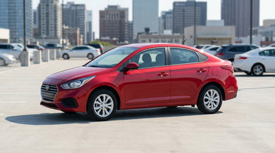 A modern car rental driving through the bustling, brightly-lit streets of New York City at night