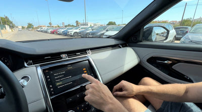 A driver adjusts the Spanish language settings on a car rental infotainment screen in Miami