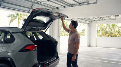 A car hire SUV with its power tailgate open inside a residential California garage