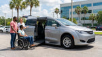 Driver adjusting the dashboard controls inside a modern Orlando car hire vehicle