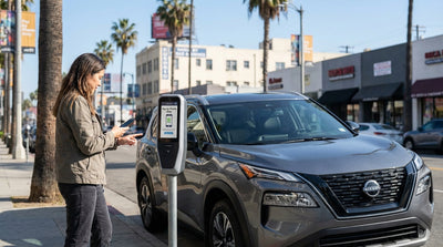 A person looks at a 'Pay by phone only' parking meter in Los Angeles, with their car rental parked on the street