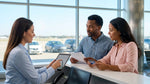 Customer signing a car rental agreement on a wooden desk in the United Estates