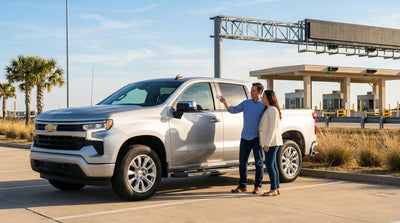 A car rental driving on a sunny Texas highway towards an electronic toll gantry