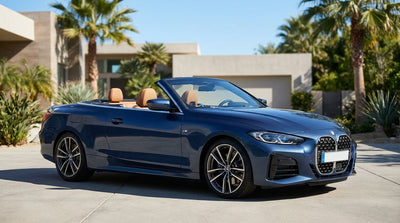 A red convertible car hire driving on a sunny, palm-lined road in Los Angeles