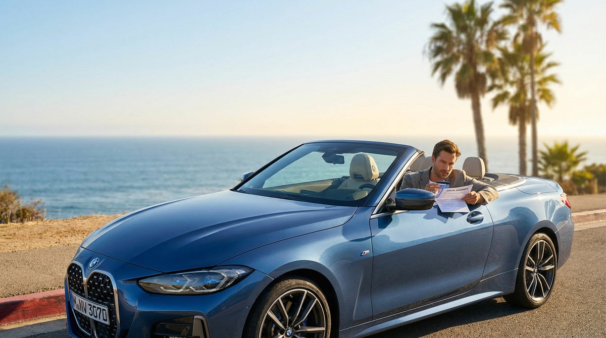 A red convertible car rental driving on a sunny, winding coastal highway in Big Sur, California