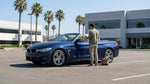 Silver car rental driving on a sunny desert highway toward Las Vegas