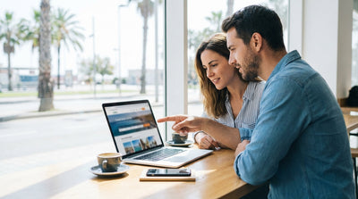 A person driving a convertible car hire down a sunny, palm-lined boulevard in Los Angeles