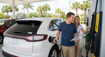 Travelers checking the E15 Unleaded 88 pump label before refueling their Florida car hire.