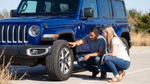 A couple inspects the tires and glass on a rental Jeep in Texas before checking coverage details.