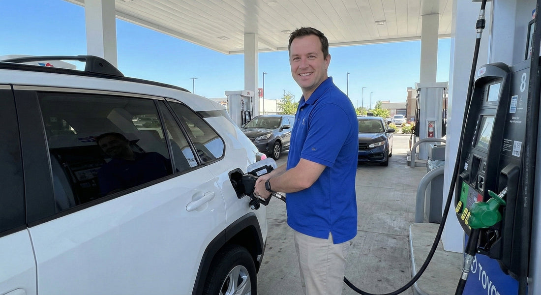Smiling man pumping gas into a white SUV car rental at a station to return the vehicle with a full tank.