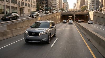 View of traffic from a car hire approaching the Lincoln Tunnel entrance in New York City at dusk