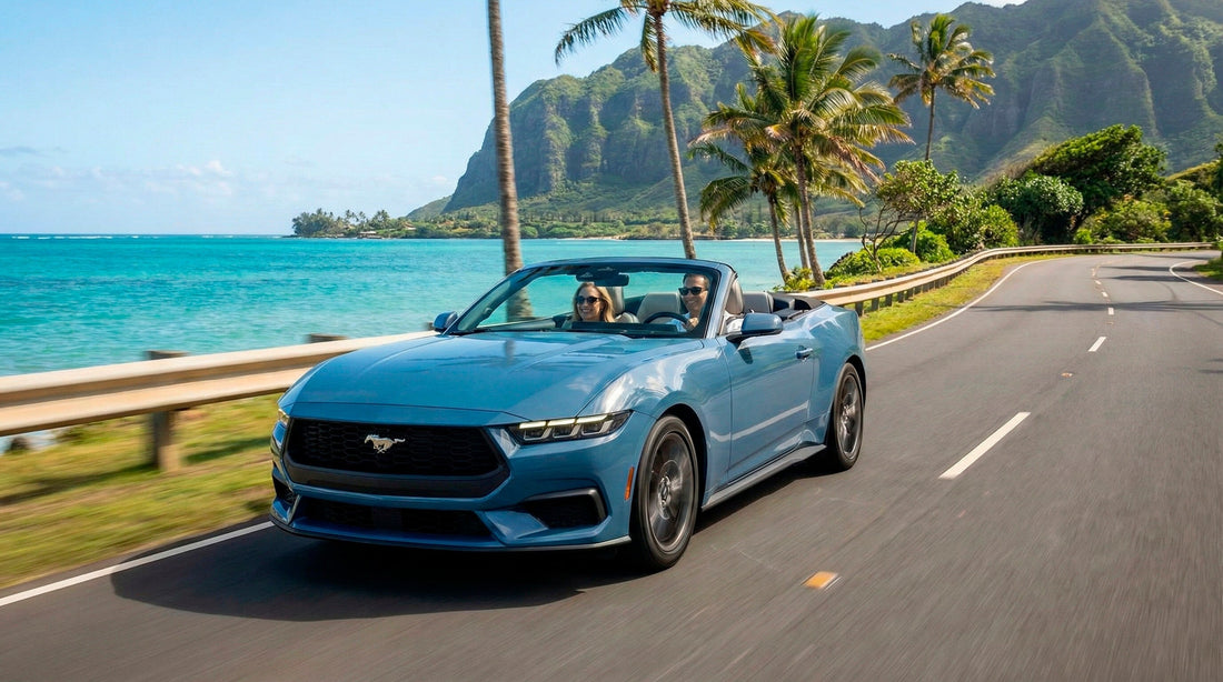 Couple driving a blue Mustang convertible car rental along the scenic tropical coast in Oahu Honolulu.