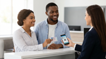 Customer shows both a physical driver's license and a digital phone ID to a car hire agent in Texas.