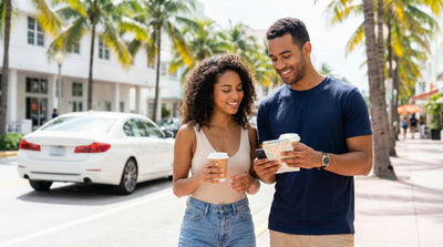 Couple walking in Miami checking a map to decide between car rental and public transport.
