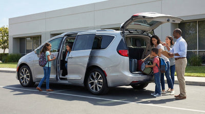 Large family loading luggage into a spacious rental van, perfect for group car hire and family road trips.