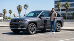 A driver in Los Angeles uses a phone for roadside assistance service next to a rental SUV.