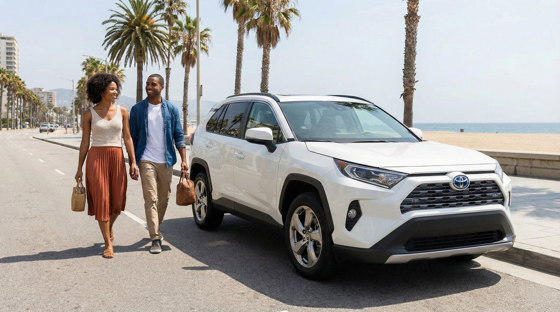 A happy couple walking away from their white Toyota Rav4 rental car parked on a street next to Santa Monica beach.