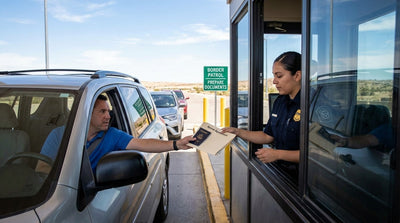 Traveler handing a passport and rental agreement to an officer at a Texas car hire border patrol checkpoint.